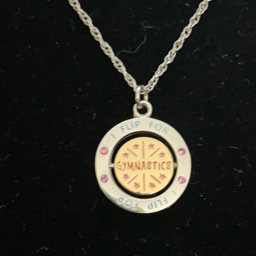 Silver toned “I Flip For Gymnastics” Spinner Necklace.